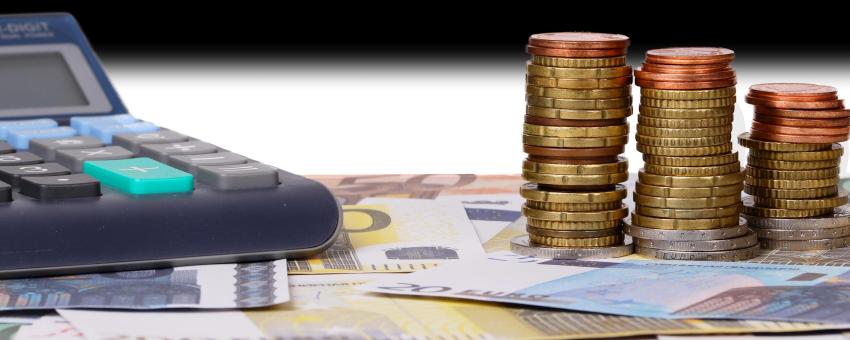 Calculator with money and coins in front of flag of Estonia