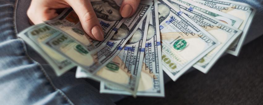 Girl holding American Dollar Bills